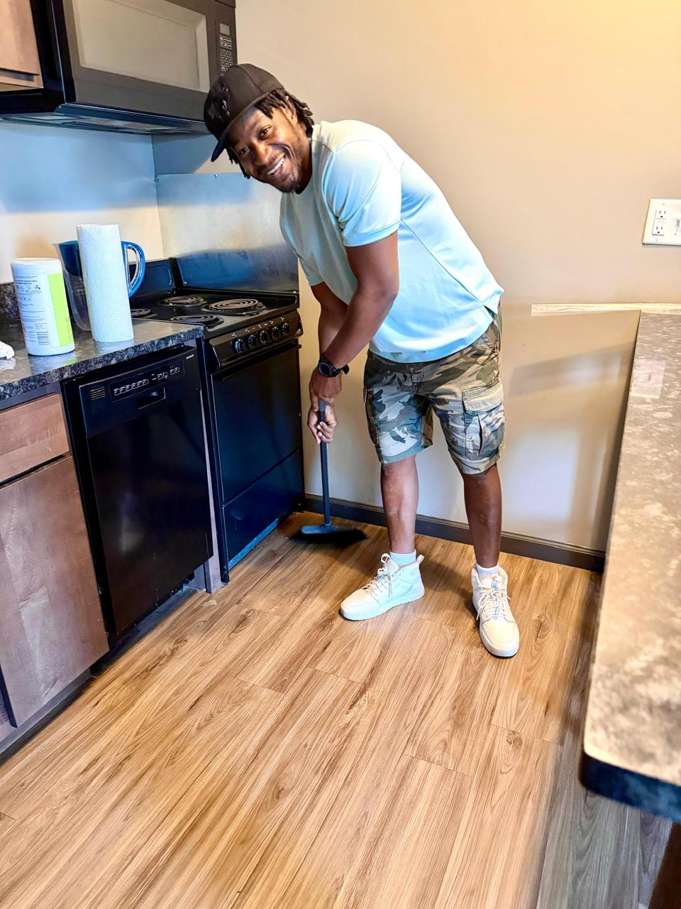 Jerry Omanichima, founder of The Vista Clean, cleaning a kitchen in Bloomington-Normal, IL